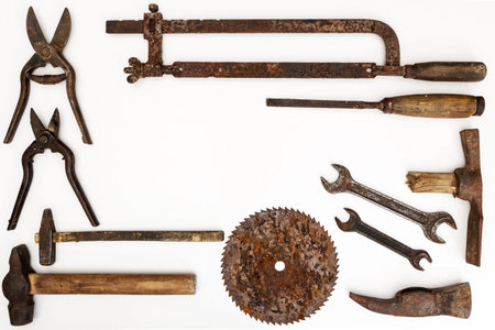 Flat lay of old hand tools on white background. Large collection of various rusty tools and bits...