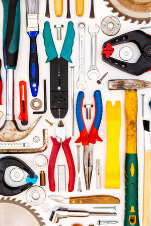 Flat lay of new and used hand tools on white background. Large collection of various tools and bits...
