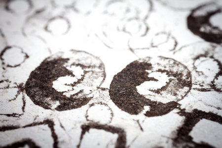 Extreme close up of black acrylic paint texture on paper. Selective focus.