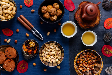 Food themed still life with various nuts and tea. Flat lay. Top view.