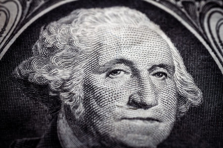 Macro close up of United States one dollar bill. Selective focus on eyes of George Washington....