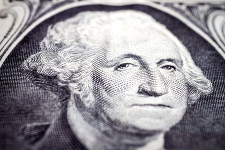 Macro close up of United States one dollar bill. Selective focus on eyes of George Washington....