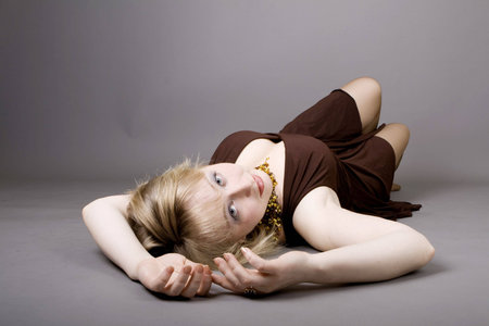 Portrait of a beautiful model laying on a blanketの写真素材