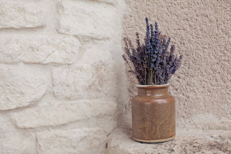 Dried lavender flowers in a vase on a stone backgroundの写真素材