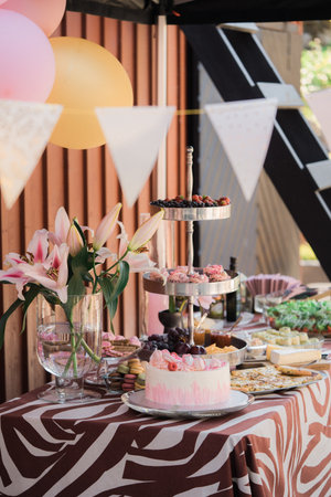 Candy bar with various sweets and pastries on the table.の写真素材