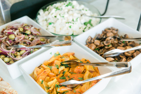 catering food for wedding party with meat and vegetables on table