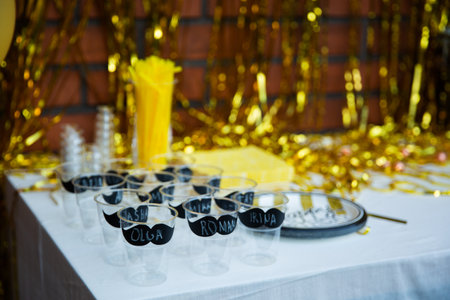 birthday party table with champagne glasses on the background of a red brick wallの写真素材
