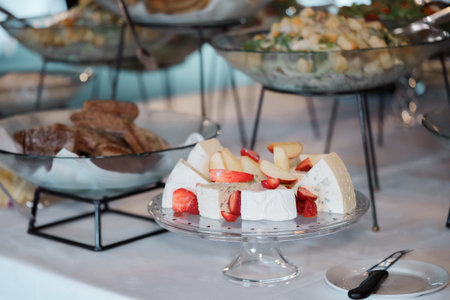 catering buffet food indoor in luxury restaurant with cheese and colorful fruits and vegetablesの写真素材