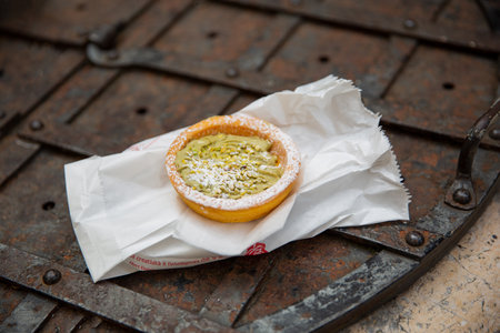 Delicious tartlet with pistachios on a baking paper.の写真素材