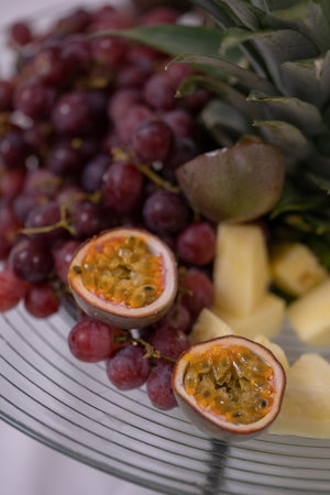 Fruit platter with grapes, ananas and passion fruitの写真素材