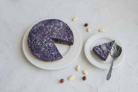 Homemade cheesecake with blueberries and nuts on a white backgroundの写真素材