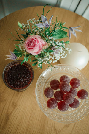 Marmelades in a glass vase on a wooden tableの写真素材