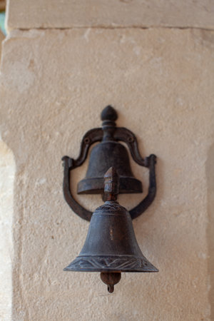Old bronze bell on the wall of a church in Provence, Franceの写真素材