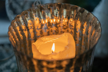 Burning candle in a glass candlestick, close-upの写真素材