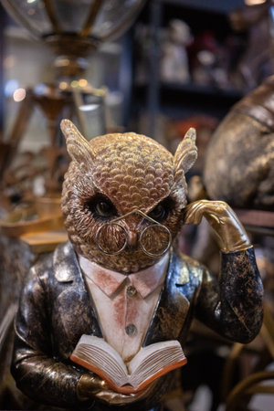 Wooden owl figurine with glasses and a book in his hands, close-upの写真素材