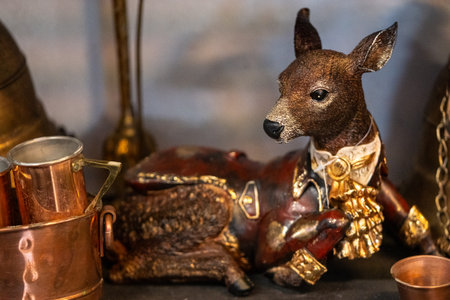 Deer figurine with copper pot, copper teapot and copper mug.の写真素材