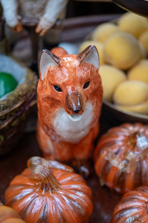 Ceramic figurine of a fox and pumpkins on a market stallの写真素材