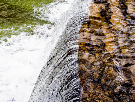 Waterfall into green river.の写真素材