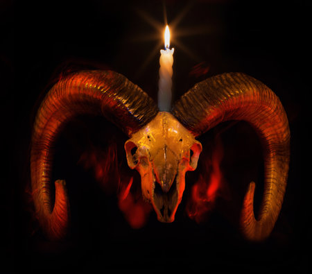 Skull of ram with lighted candle - Baphometh symbol from Taro cardsの写真素材