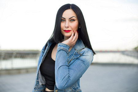 Gothic woman at the street in the jeans jacketの写真素材