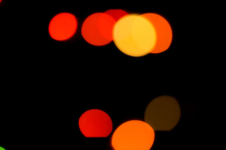 Colored bokeh textures - abstract photo on the black background for adding and editing as the background layer in the multiply regimeの写真素材