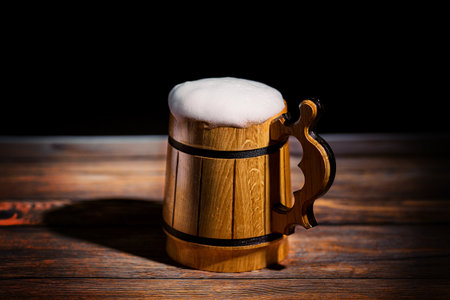 Mug with beer on the old wooden bar table - Close up photo