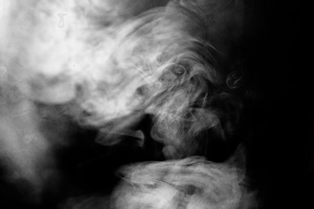 Smoke texture for designers works - abstract photo texture of the real smoke on the black background for adding and editing as background layer in the screen regimeの写真素材