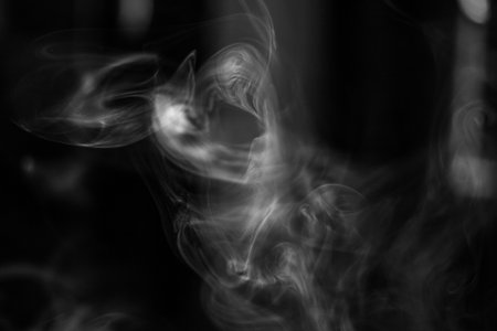 Smoke texture for designers works - abstract photo texture of the real smoke on the black background for adding and editing as background layer in the screen regimeの写真素材