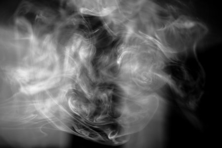 Smoke texture for designers works - abstract photo texture of the real smoke on the black background for adding and editing as background layer in the screen regimeの写真素材
