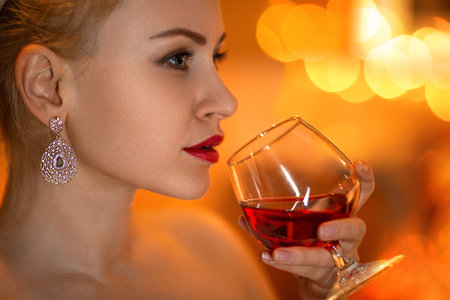 Portrait of the beautiful woman with the glass of wine in her hand. Close up beauty portrait.の写真素材