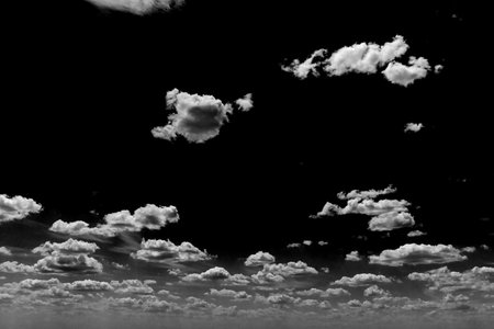 Real clouds and sky hi-res texture for design and retouch - abstract photo texture of the real clouds on the black background for adding and editing as a background layer in the Screen blending modeの写真素材