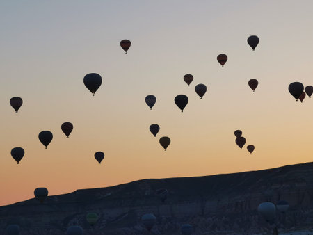 A Cappadocian morning with sunrise on the amazing background of flying balloons. Cappadocia, Goreme...