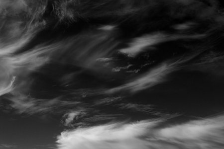 Real clouds and sky hi-res texture for design and retouch - abstract photo texture of the real clouds on the black background for adding and editing as a background layer in the Screen blending modeの写真素材
