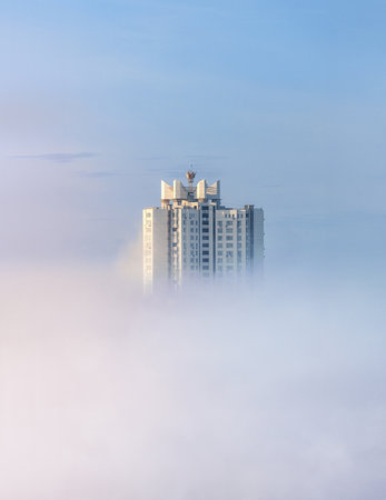Skyscraper of Kyiv in the background of morning fog and dust from Africa - architecture minimalism conceptual landscape photoの写真素材