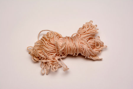Close-up coiled silk rope on the light background