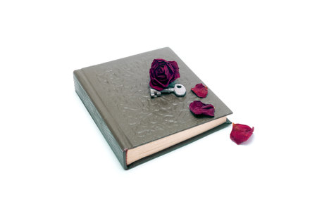Dried rose with a key on the old bookの写真素材