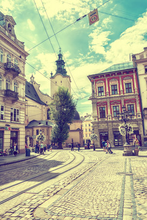 Lviv, Ukraine - August 15, 2016: Historic center of Lviv on the corner of Market Square near Latin Cathedral. Vintage tonedのeditorial素材