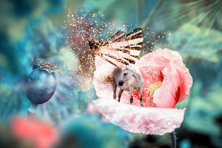 White fairy unicorn with butterfly wings on blooming pink poppy flower. Realistic fairytale magic manipulation. Vintage toned.の写真素材
