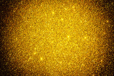 Abstract golden sparkle glitter shiny holiday texture. Gold shallow depth background. Greeting card template. Copy space.の写真素材