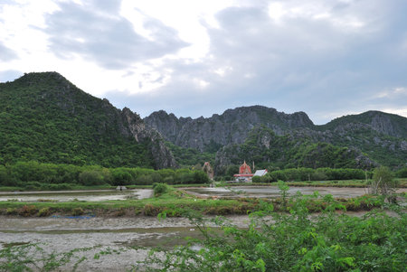 Temple surrounded by mountains. Temple in the forest behind the mountains.の写真素材