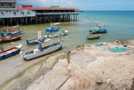 Fleet of small wooden fishing boats in the fishing village of Hua-Hin, Thailand.の写真素材