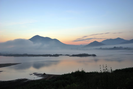 Light morning with fog obscured the mountains and river.の写真素材