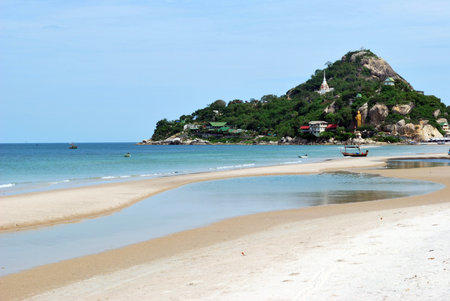 beach with mountain and buddha statue in hua-hin beach, thailandの写真素材