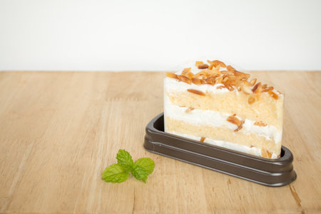 Macadamia cake with Plastic wraps in package on wooden table background.の写真素材