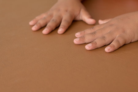 Soft focus of hands put on brown Leather desk, Serious action.の写真素材