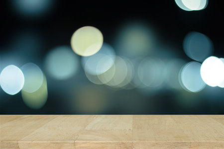 Wooden desk with Blue bokeh. Blurred light on blue background.