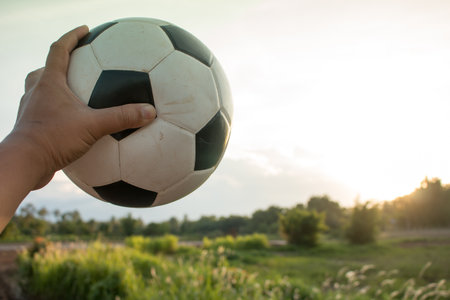 Hand holding soccer ball.の写真素材