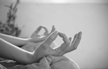 Soft focus of hands  do yoga .Young woman do yoga indoors.の写真素材