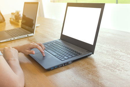 Close-up of Asia's woman working on laptop while sitting at the coffee shop.