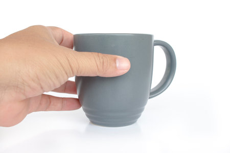 Hand holding Gray coffee mug  on white backgroundの写真素材
